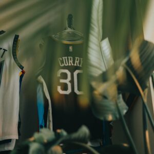 a basketball jersey on a table next to a plant