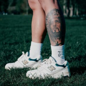 person wearing white nike athletic shoes